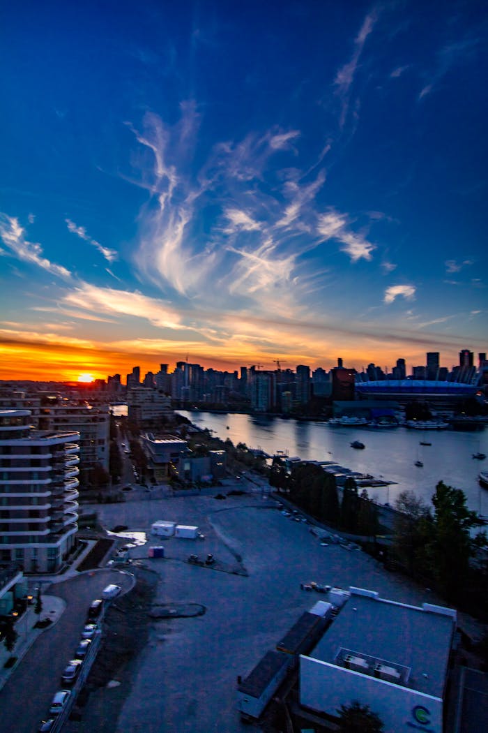 Stunning view of Vancouver skyline at dusk, with vibrant sunset and waterfront scene.
